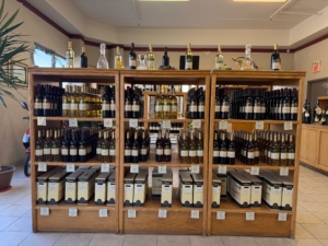 Wine bottles displayed on wooden shelves.