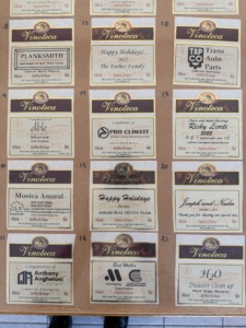 Vinoteca sponsorship plaques displayed on a board.