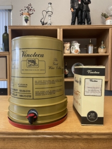 Wine barrel and box on wooden table.